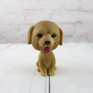 Detail of nodding golden dog car ornament with realistic fur texture and cute expression