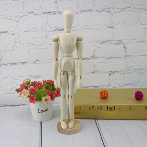 Detailed view of posable wooden mannequin with adjustable joints on a round base