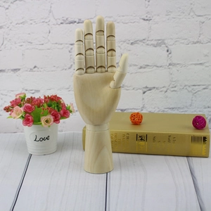 Detailed view of flexible joints on a wooden hand model for sketching and home decor