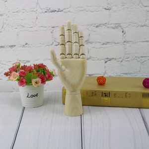 Detail of a poseable wooden mannequin hand with adjustable finger joints for sketching