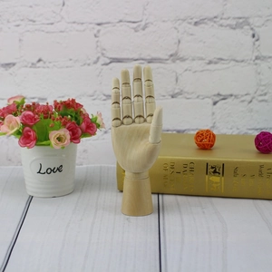 Articulated wooden hand model for sketching with flexible joints on a white background