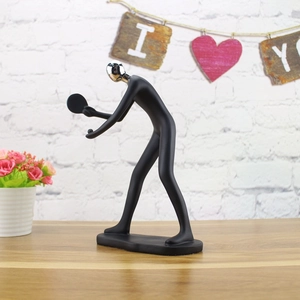 Detailed view of an abstract ping pong athlete sculpture in matte black and mirror silver finish