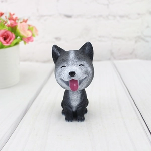 Detailed view of a grey resin nodding dog ornament with realistic fur textures on wood