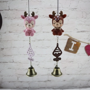Close-up of pink and brown cartoon deer wind chimes with sweet wood tags and metal bells