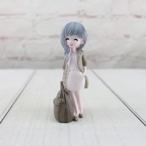 Detailed view of cartoon girl figurine with blue hair and woven texture cardigan