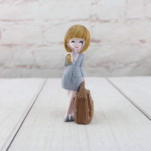 Detail of cartoon businesswoman resin figurine in grey checkered suit on wood surface
