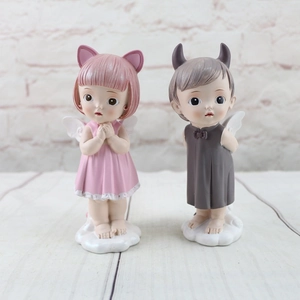 Close-up of resin dream angel figurines with wings for wedding cake and home decor