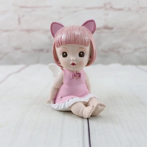 Close-up of cute resin angel girl figurine with pink cat ears and white wings