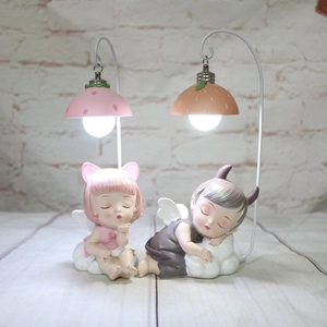 Cartoon angel and devil night lights on strawberry and orange stands for cake decor