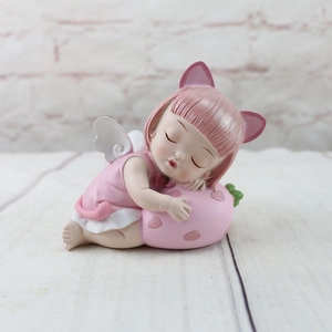 Detailed view of resin angel girl figurine with pink cat ears sleeping on a strawberry