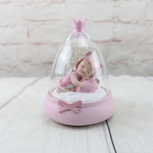 Close-up of pink dream girl night light with crown glass dome and LED lights
