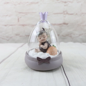 Detail of LED crown night light with sleeping angel figurine and strawberry accents