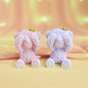 Detail of pink and purple bears with golden crowns and unique textured finish