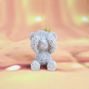 Detailed view of gray bear figurine with golden crown and unique textured fur finish