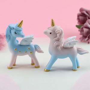 Pair of dreamlike unicorn cake toppers with glitter wings for room and party decor