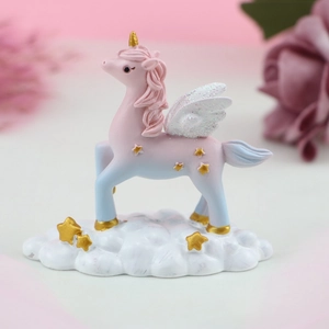 Detailed view of dreamy gradient unicorn figurine with golden wings on cloud base