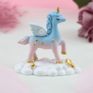 Detailed view of dreamy unicorn figurine with glitter wings and stars on cloud base