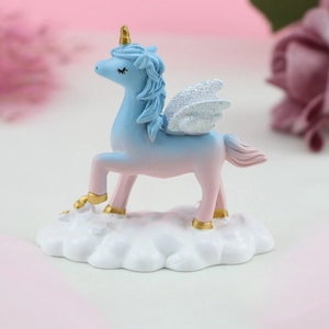 Macro shot of a dream unicorn cake topper with pink blue gradient on white cloud base
