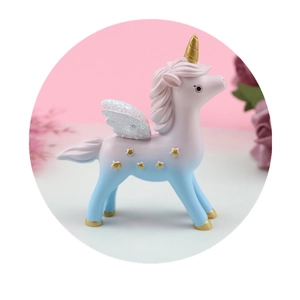 Dreamy gradient unicorn cake topper with golden stars and glittery white wings