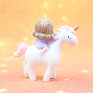 Detail of creative resin unicorn figurine featuring a girl with golden horn and pink mane