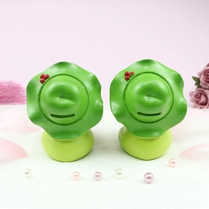 Creative green frog night light money box with lotus leaf hat on elegant pink background
