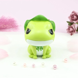 Close-up of cute green frog night light figurine with lotus leaf hat on floral background