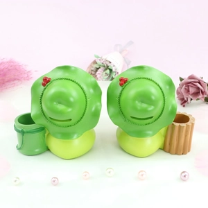 Detail of cartoon frog night light and money box with miniature storage baskets