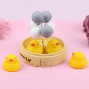 Miniature yellow ducklings with balloon ornaments on a bamboo steamer base decor