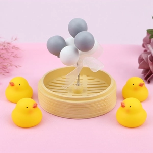 Close-up of mini duck figurines with balloon bouquet in a bamboo steamer decor