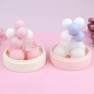 Close-up of cute mini kittens and colorful balloons in small bamboo steamer trays