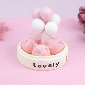 Pink piggy figurines in a 'Lovely' steamer basket with balloons car interior decor
