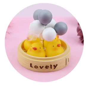 Cute yellow duckling in bamboo steamer with balloons for desk and car decoration