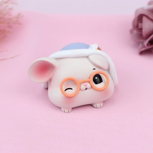 Gros plan d'une figurine de hamster avec lunettes oranges et bonnet en tricot bleu