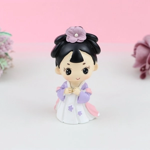 Close-up of a cute Chinese princess cake topper with purple flowers and resin details