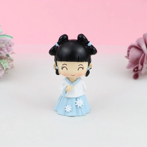 Detail of Q-version doll in white and blue Hanfu dress with fan for cake decoration