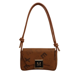 Brown leather crossbody bag with EXO letter print and golden M buckle on white background