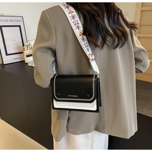 Contrast leather crossbody bag with wide embroidered strap and gold brand lettering