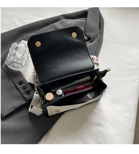 Interior view showing the spacious capacity and magnetic buckle of the contrast color bag