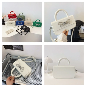 Multiple views of a rectangular crossbody bag with a sparkling crystal bow decoration