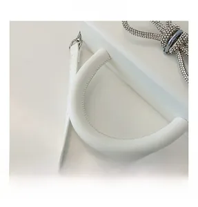 Detailed macro view of comfortable white leather handle with sparkling rhinestone bow