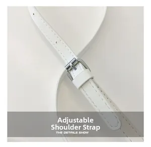 Detail of adjustable white leather shoulder strap with silver buckle for crossbody bag