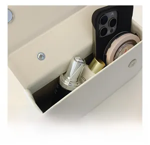 Internal view of cream bow box bag showing capacity for phone and cosmetics