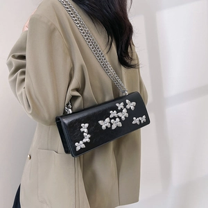 Elegant black chain bag with silver butterfly charms shown as a shoulder crossbody bag