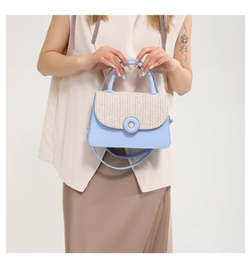 Close-up of woven patchwork crossbody bag with blue base and metal ring buckle detail