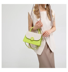 Detail of contrast color woven texture bag with neon green circular buckle and handle