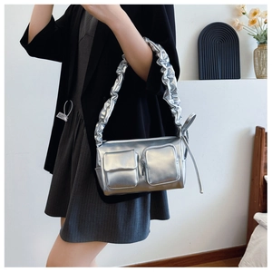 Close-up of silver crescent underarm bag with scrunchie strap and dual pockets