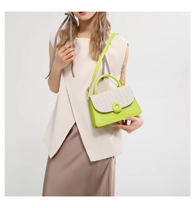Chic lime green and beige woven crossbody bag worn by a model in a minimalist studio