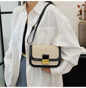 Detail of vintage linen patchwork bag with gold square buckle and adjustable leather strap