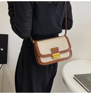 Rear view of a model wearing a retro linen and brown leather crossbody square bag