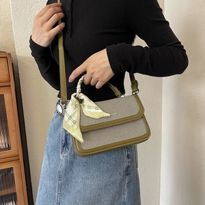 Fashionable striped canvas handbag with olive green trim and a silk scarf handle detail